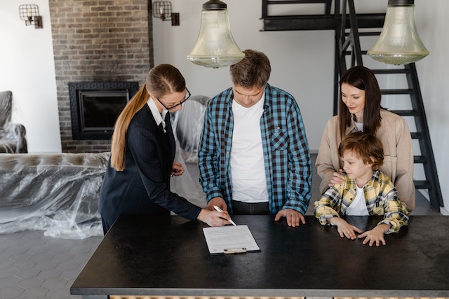 A Folsom property manager signing a lease in a house with a family of two adults and one child